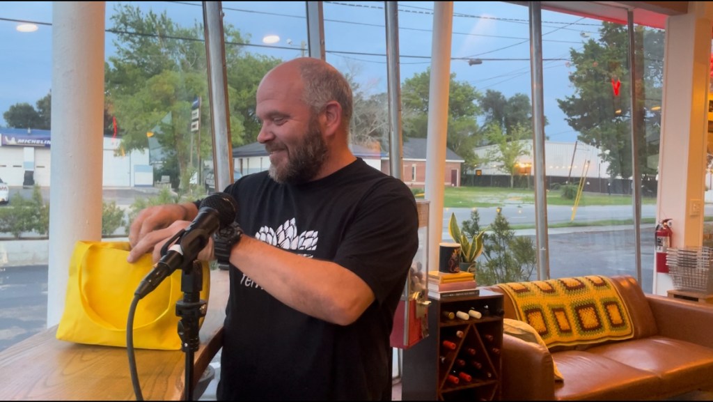 Ashley Rogers finding out what the surprise snack is during an episode of Sips and Snacks