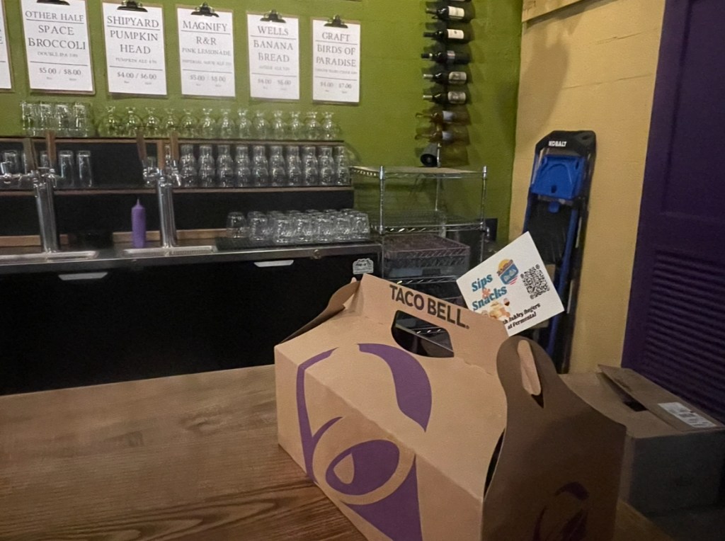 A Taco Bell party pack of tacos with a Sips and Snacks card placed in it, at Fermental