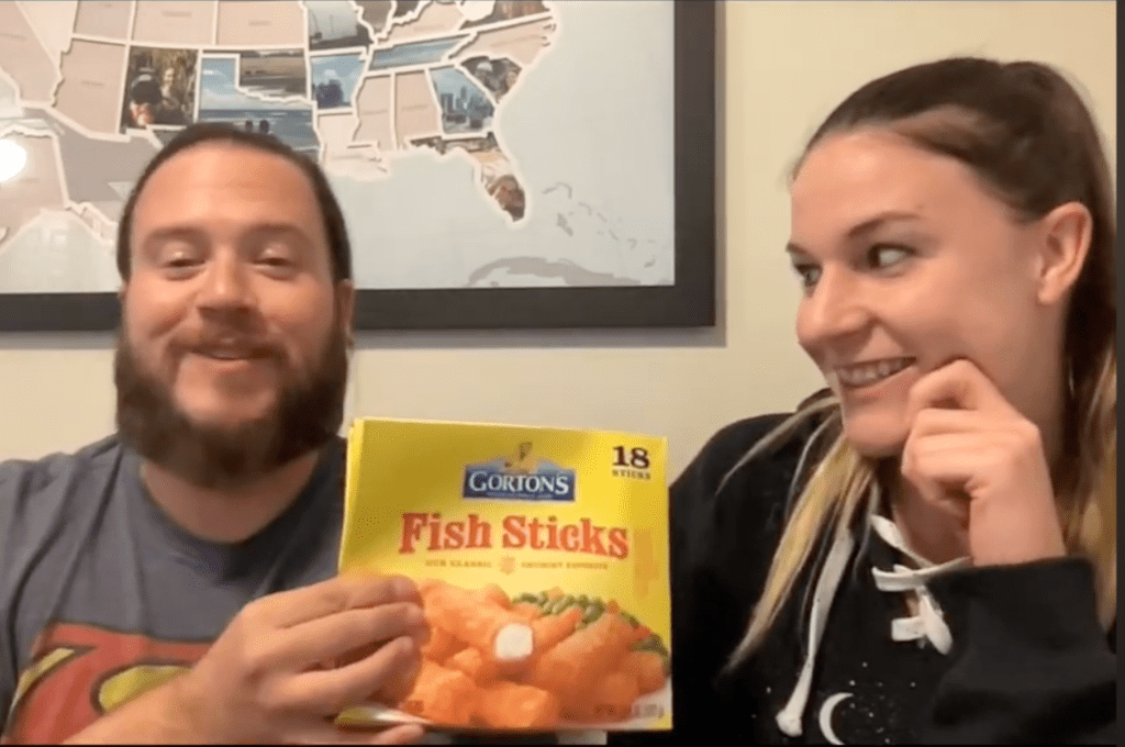 Luke and Naomi Holding Up a Box of Fish Sticks