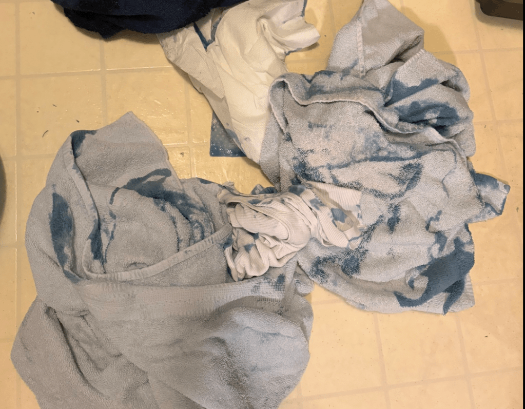 Pile of towels covered in laundry soap